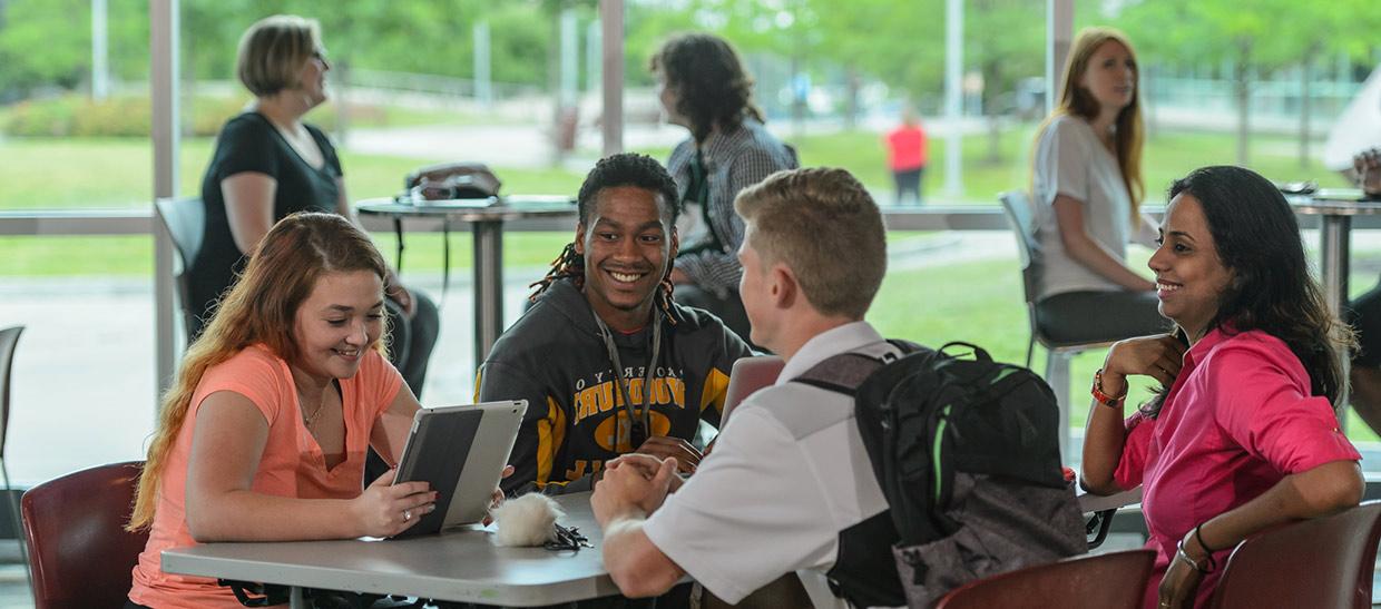 Students sitting at a table in the campus center